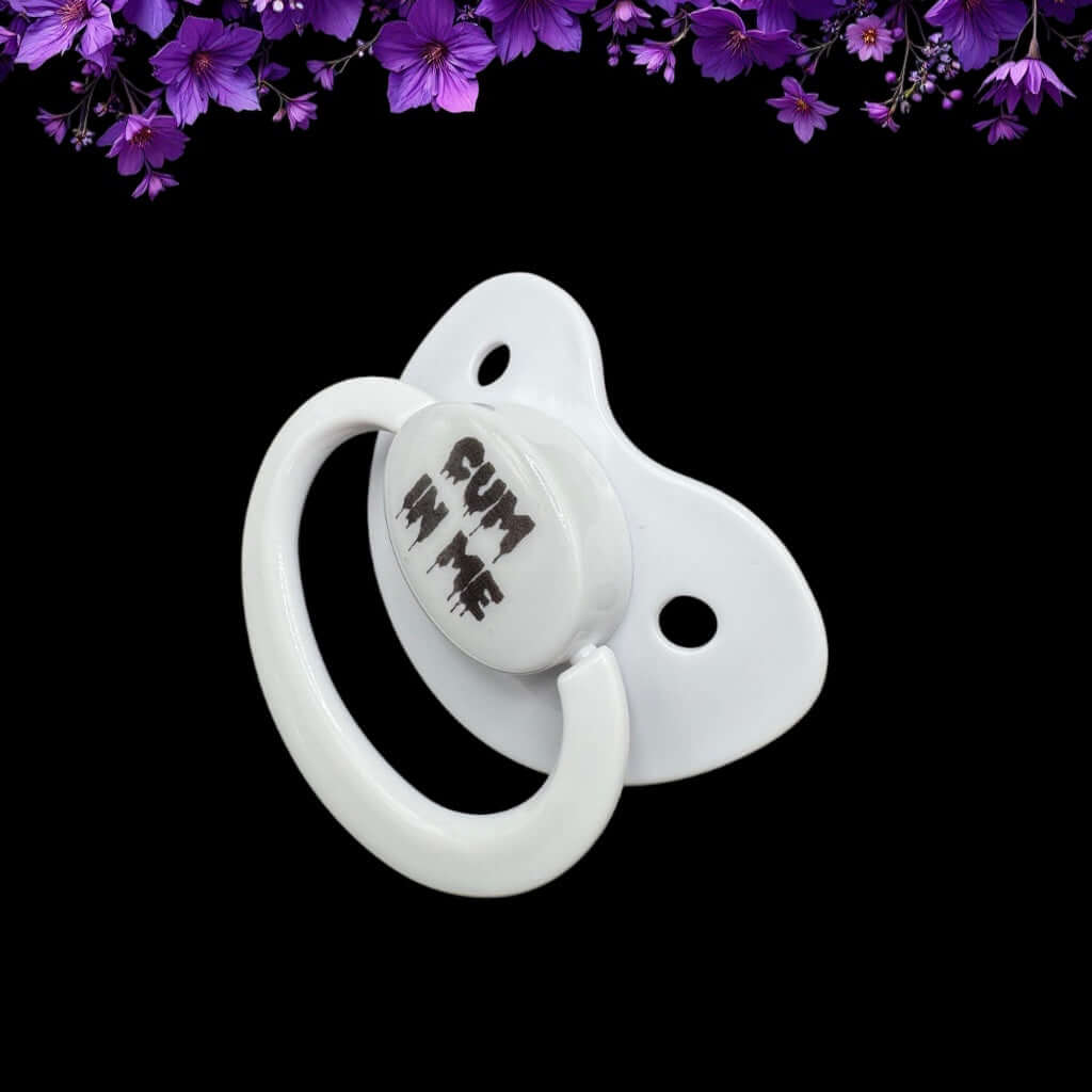 white adult pacifier with black dripping text that reads Cum in Me