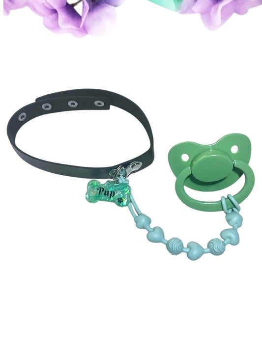 Adult pacifier choker featuring a comfortable choker with an attached adult pacifier, connected by a chewable silicone string. A customizable resin name tag is displayed at the center for personalization.