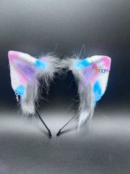 Colorful cat ears with white fur on a black background