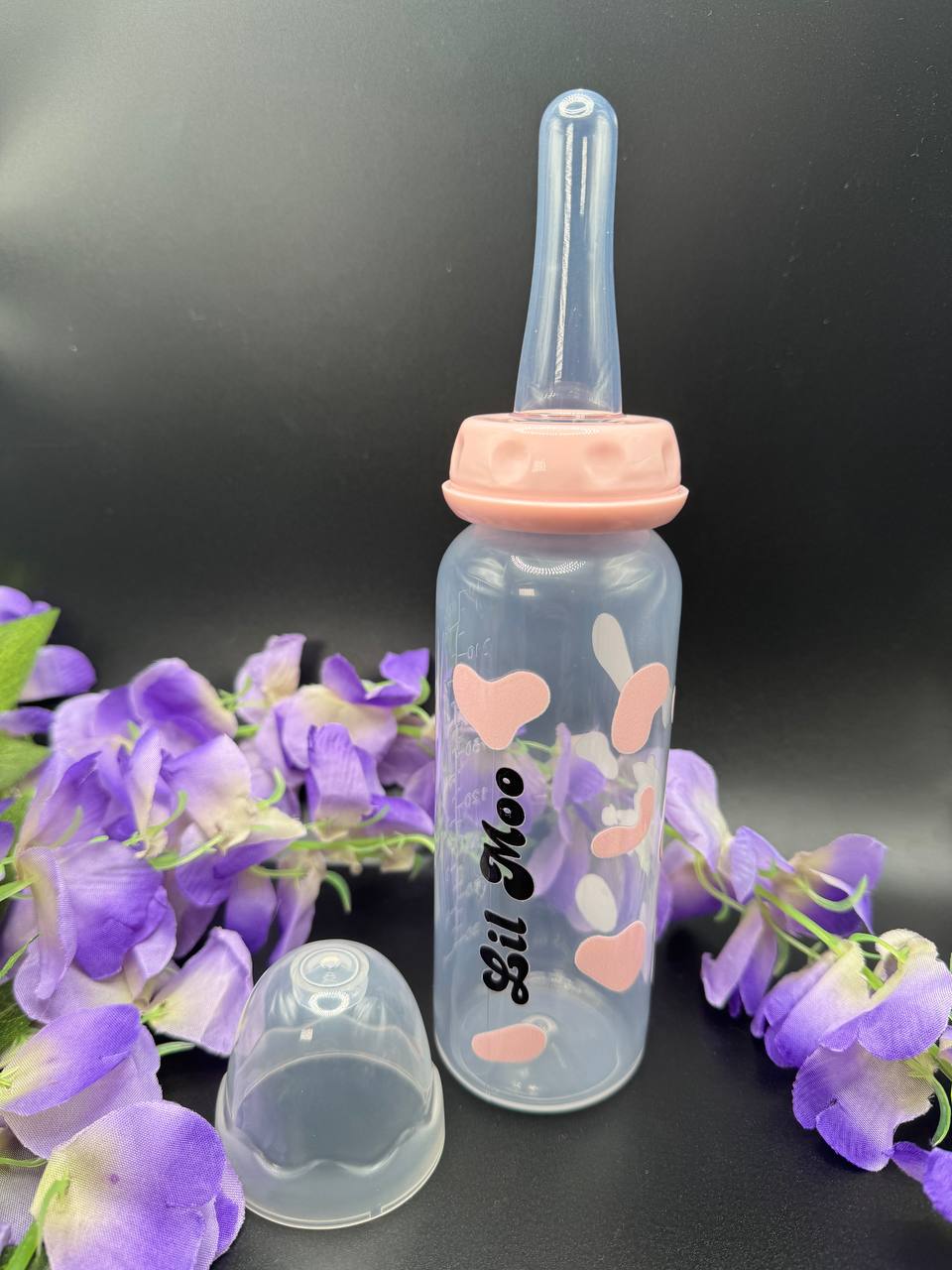 Lil Moo pink cow ABDL adult baby bottle with kawaii cow design and text “Lil Moo” on the front