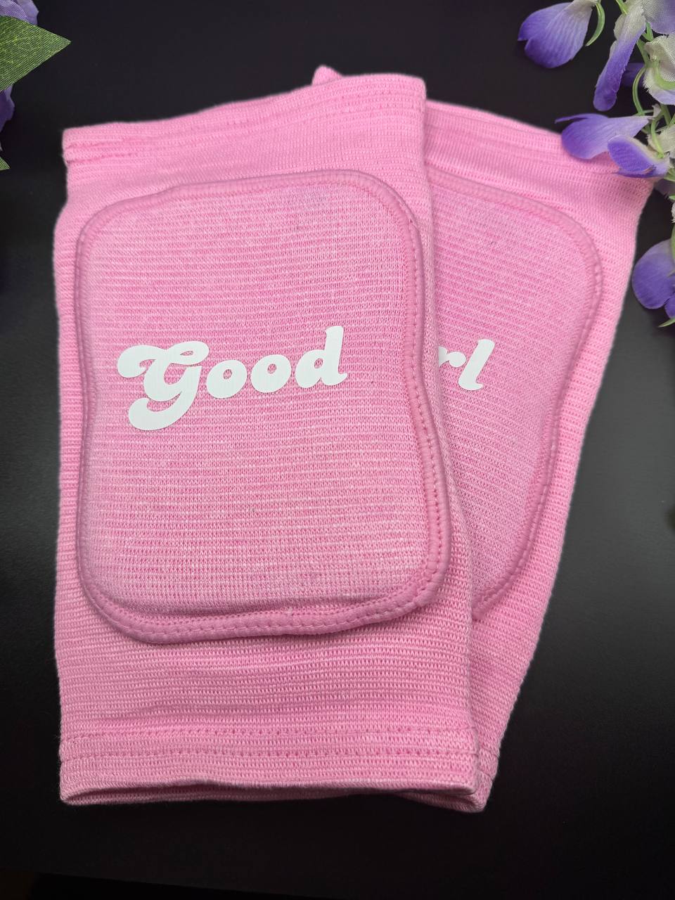 baby pink knee pads with Good on one side and girl on the other