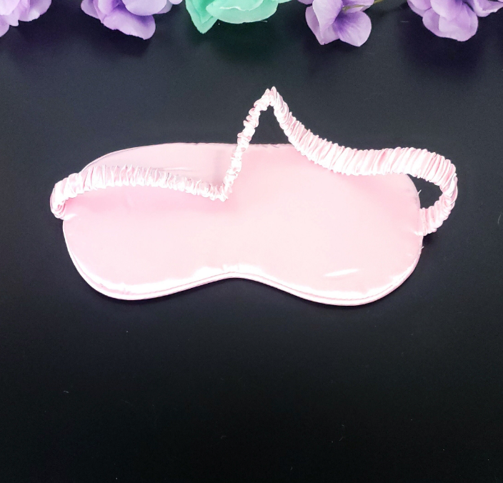 Back view of light pink silky eye mask