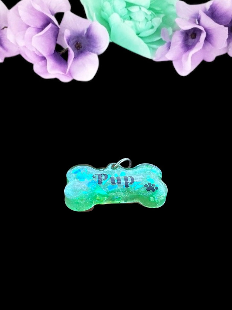 Vibrant green resin pet play tag featuring the word 'Pup' in bold black lettering with a black paw print, combining a playful and stylish design.