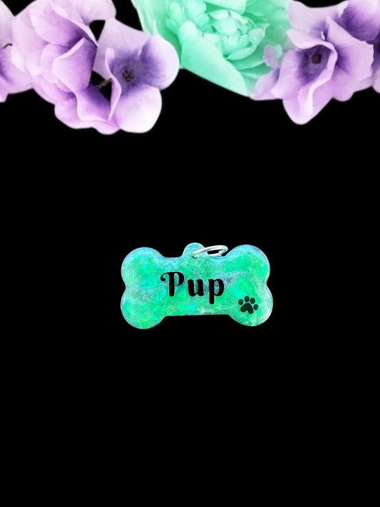 Vibrant green resin pet play tag featuring the word 'Pup' in bold black lettering with a black paw print, combining a playful and stylish design.