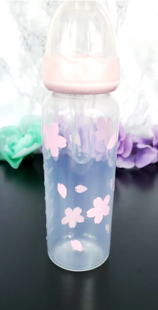 An 8oz adult baby bottle featuring a delicate sakura cherry blossom theme, with soft pink flowers and petals elegantly wrapping around the bottle for a serene and charming design.