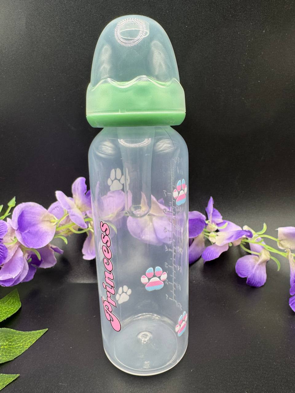 Clear adult baby bottle with mint cap and 'Princess' text and paw prints that are pink, blue and white