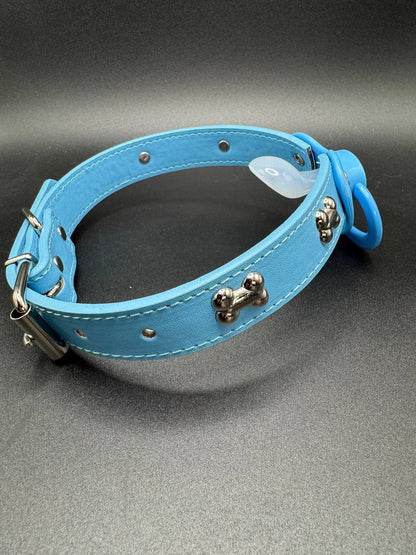 Blue leather dog collar straps with metal dog bone studs with adult pacifier attached