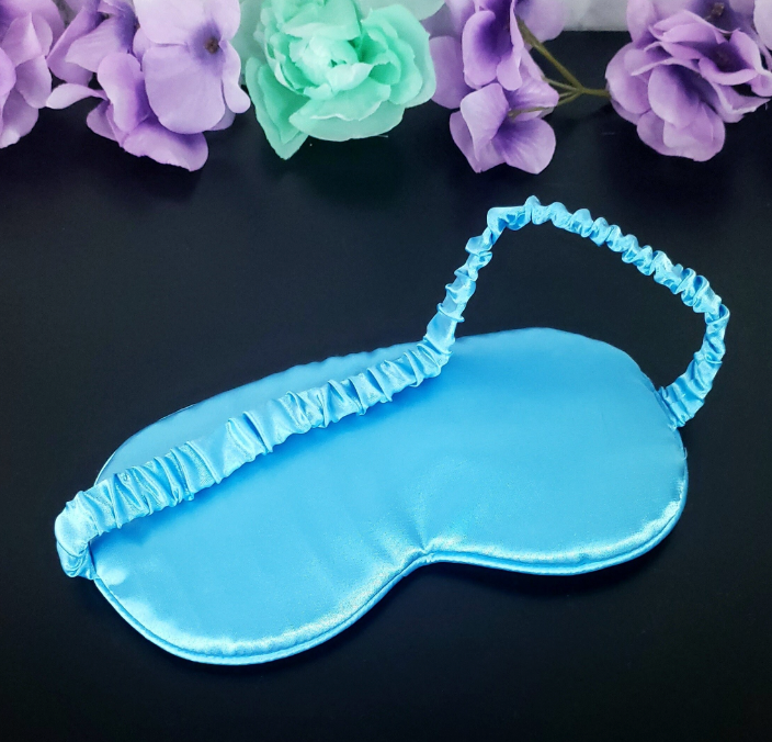 Back view of light blue silky sleep mask