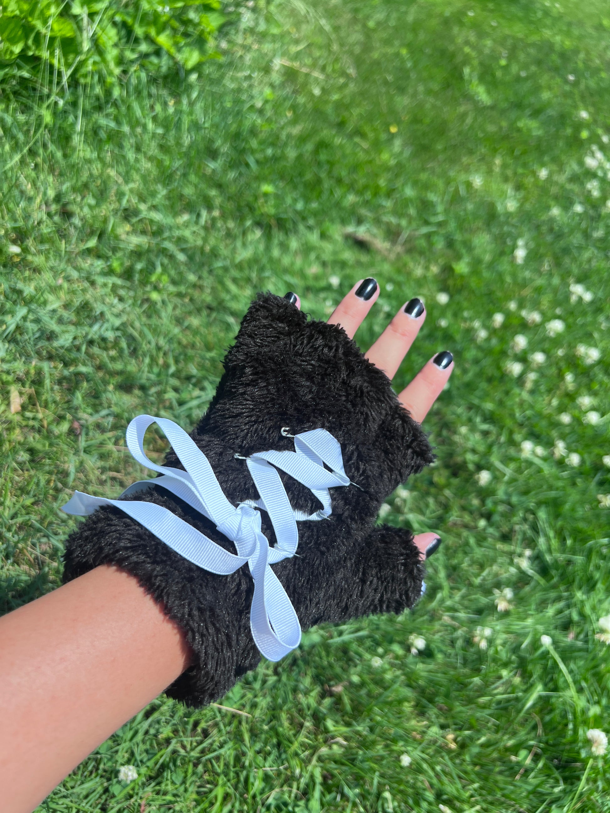 Black pet play paws that are fingerless and have ribbon corset on the back side