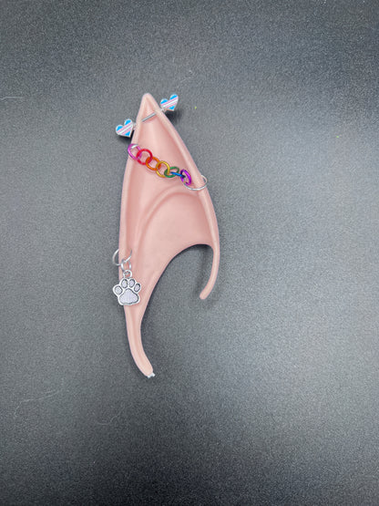 elf ear with paw charm earring, rainbow chain and barbell piercing with trans pride hearts
