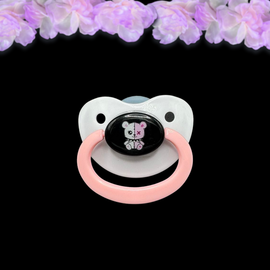 adult pacifier with two colored white and pink gothic punk bear image in the center