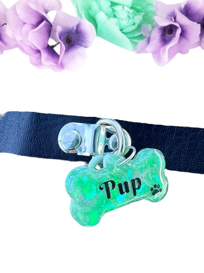 Vibrant green resin pet play tag featuring the word 'Pup' in bold black lettering with a black paw print, combining a playful and stylish design."