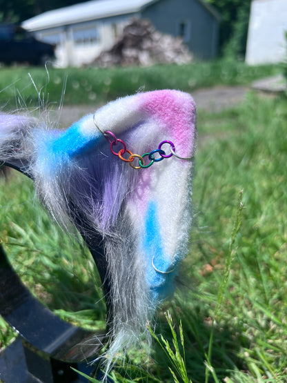 Close-up of a costume kitten ears with rainbow piercing