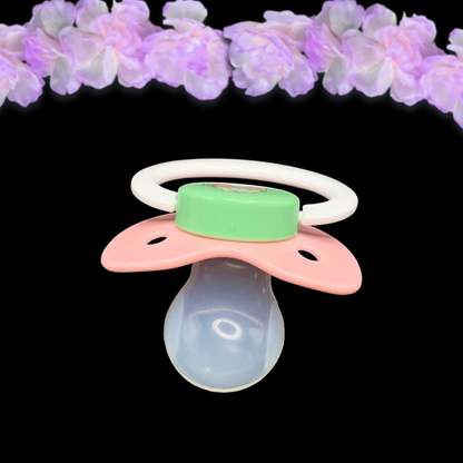 top view of adult pacifier showing shape of the clear reinforced pacifier nipple