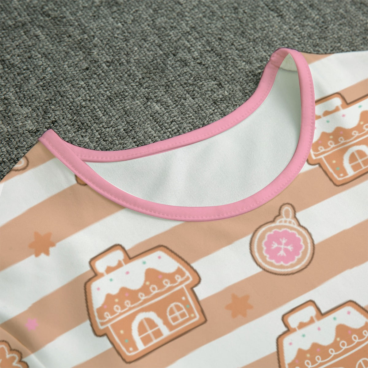 Up close view of adult baby gingerbread bodysuit with pink trim