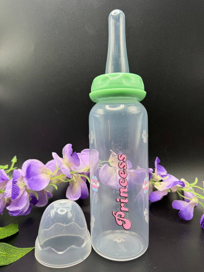 Clear ABDL baby bottle with green cap and 'Princess' text, surrounded by paw prints