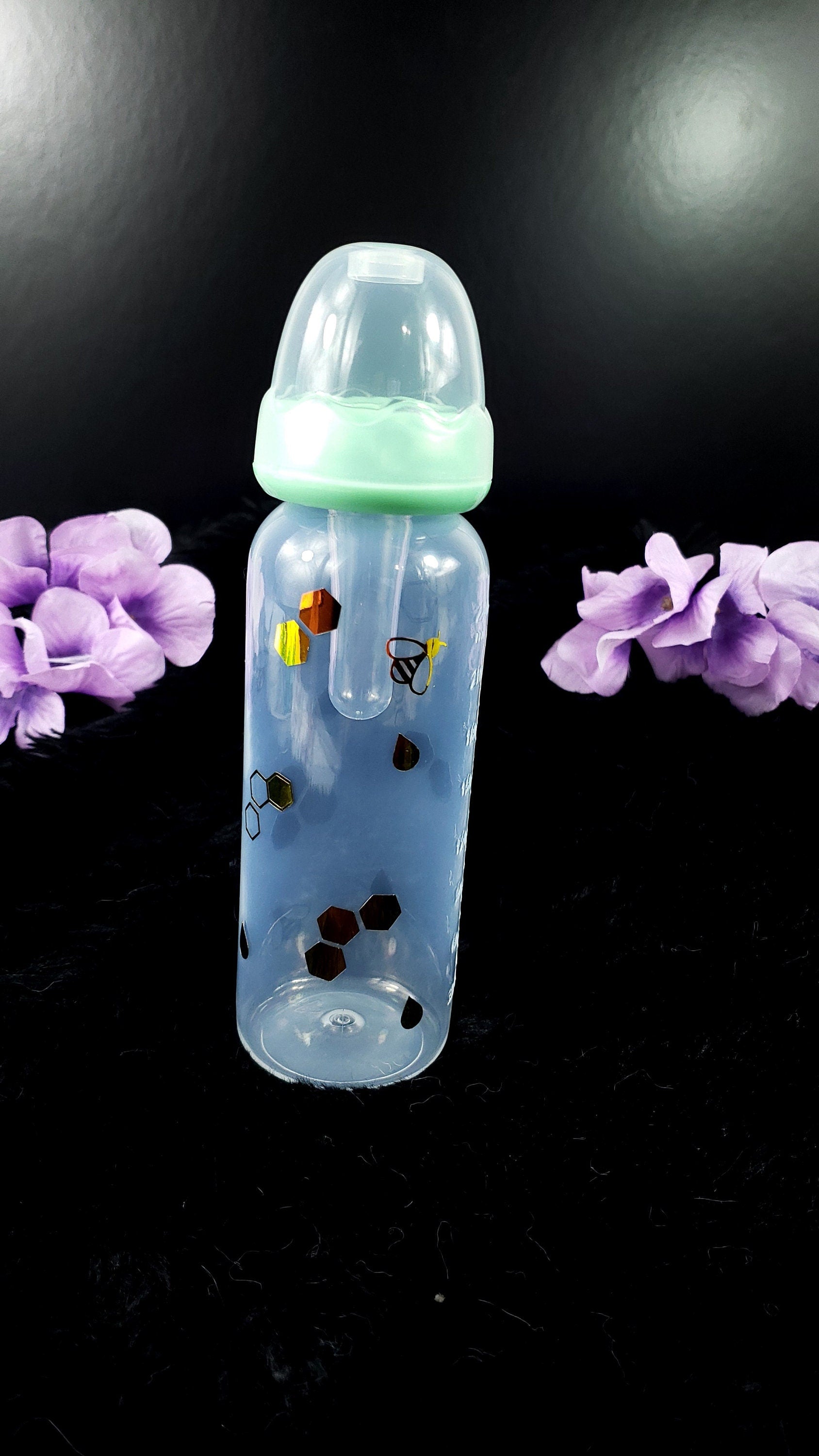 An 8oz ABDL bottle featuring a cheerful bee theme, with cute bees, honeycombs, and vibrant honey gold accents wrapping around the bottle for a playful and whimsical design.