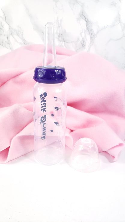 An 8oz adult baby bottle with the phrase "Milk Drunk" written in bold black text across with silhouette milk drops, offering a playful design.