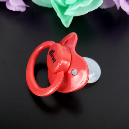 A red adult pacifier featuring the word "Brat" boldly displayed in the center, designed for playful and cheeky self-expression.