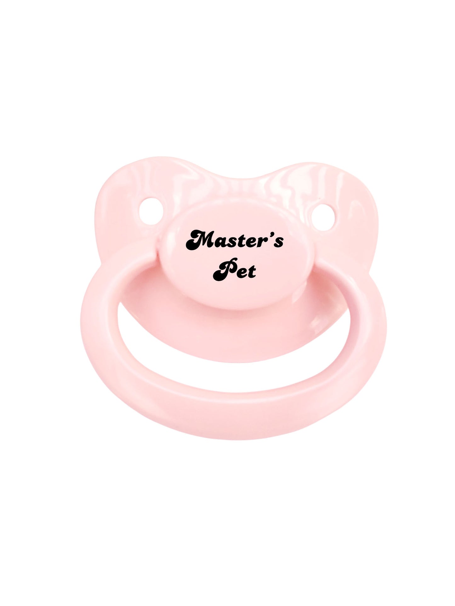 A baby pink adult pacifier with elegant black text in the center that reads "Master's Pet," featuring a soft and playful design.