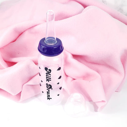 An 8oz adult baby bottle with the phrase "Milk Drunk" written in bold black text across with silhouette milk drops, offering a playful design.