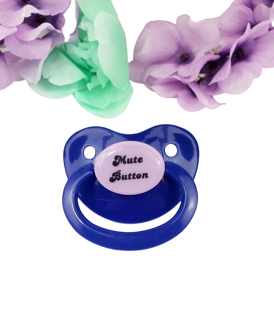 A dark blue adult pacifier with elegant black text in the center that reads "Mute Button," featuring a soft and playful design.