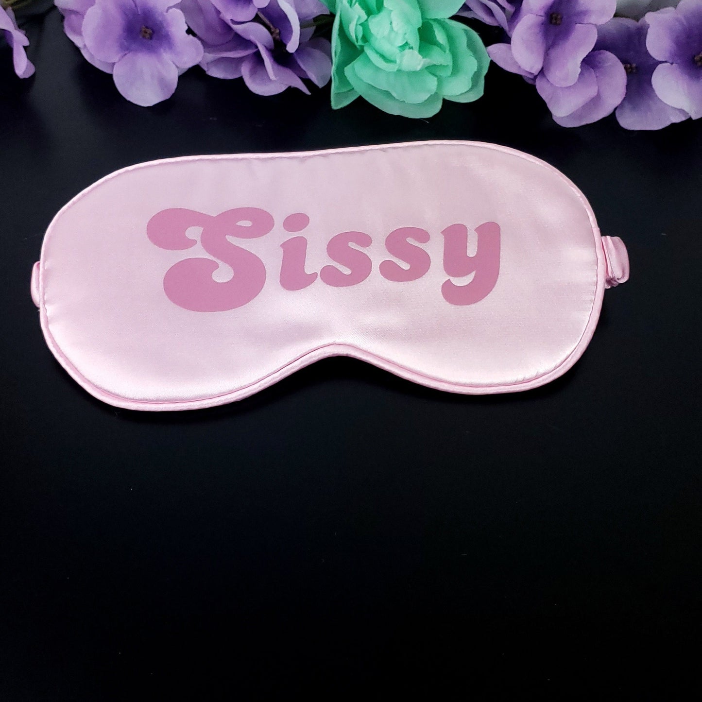 pink sleep mask with the word Sissy in a darker pink
