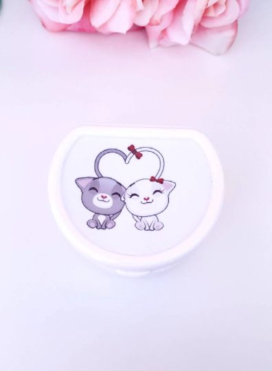 ABDL pacifier case featuring happy cats creating a heart with their tails on the lid, adding a playful and cheerful touch to pacifier storage.