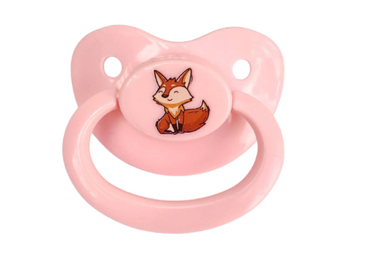 A pink adult pacifier with a cute cartoon fox design in the center.