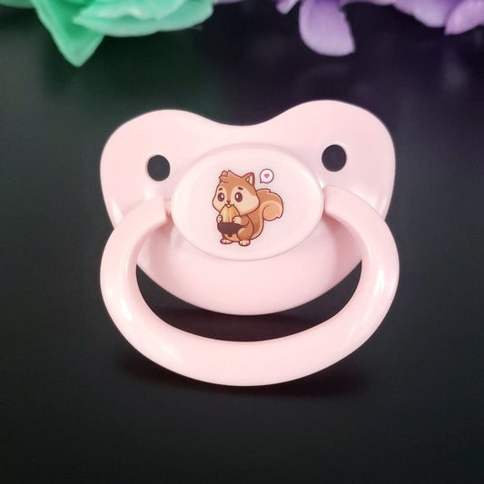 baby pink adult pacifier with kawaii squirrel eating an acorn