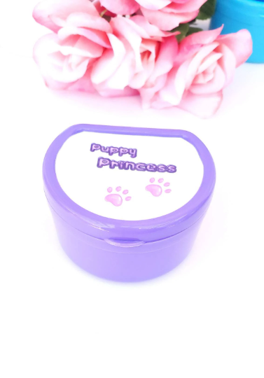 Adult pacifier case featuring the text 'Puppy princess' on the lid with cute paw print accents, designed for stylish and convenient pacifier storage.