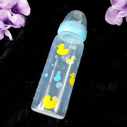 An 8oz adult baby bottle featuring a playful design with yellow ducks and blue bubbles, creating a fun and whimsical bath-time-inspired theme.