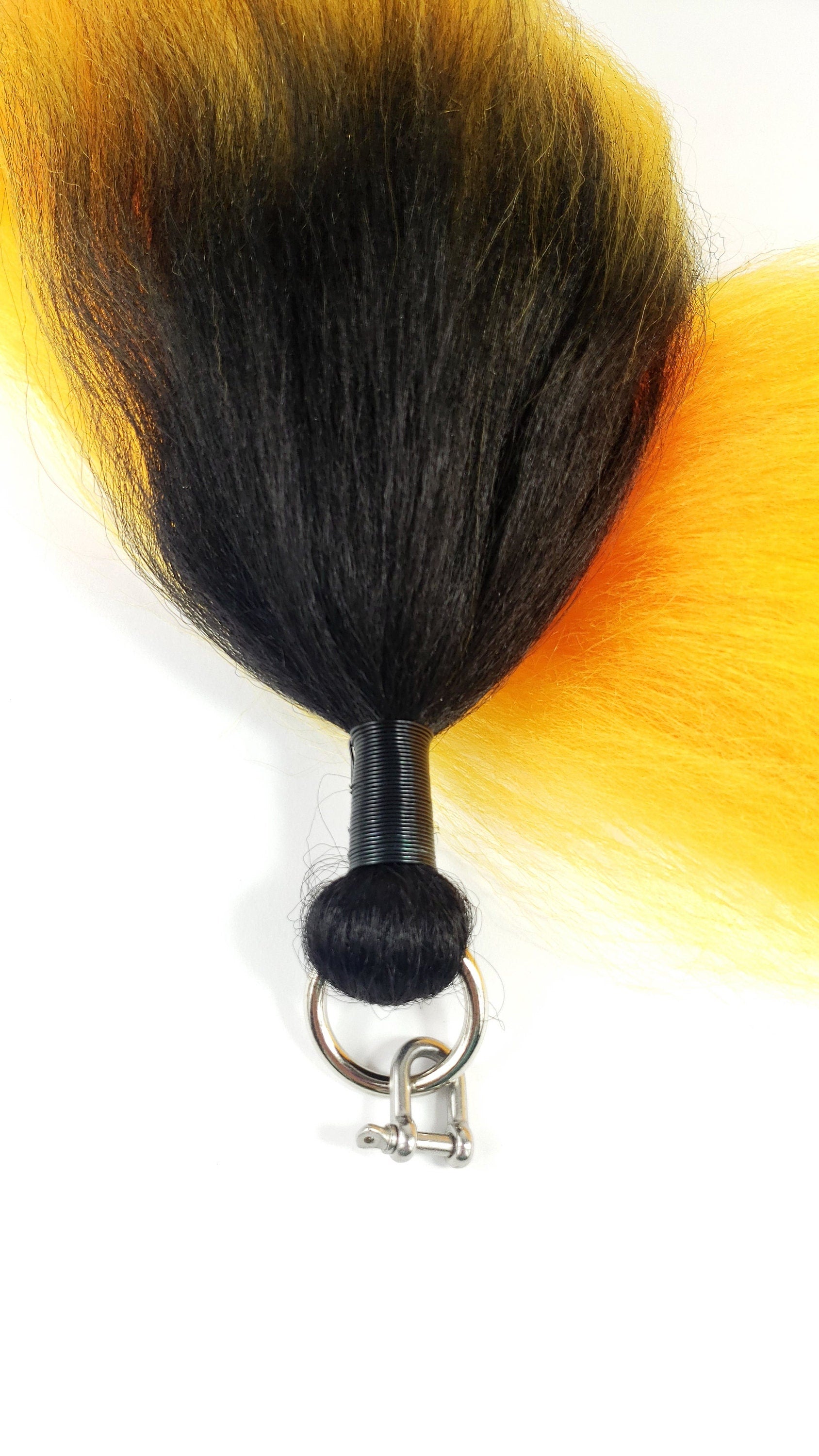 close up view of costume black and yellow pony tail with wire wrapping and O ring attachment